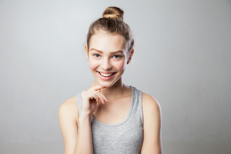 carefree portrait of a woman laughing and having fun. real person on grey backgroundの写真素材