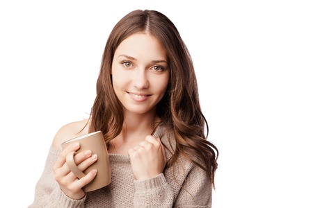 Coffee cup. Young woman on isolated studio background drink coffee. Beautiful girl portraitの写真素材