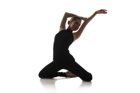 young modern ballet dancer posing on white backgroundの写真素材