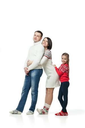 portrait of happy young family standing together isolated on whiteの写真素材