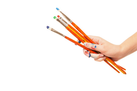 Hand holding brushes up. Isolated on whiteの写真素材