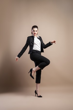 Beautiful model posing on beige background .の写真素材