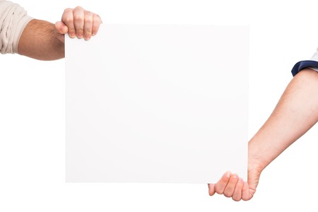Hands holding a blank white board. isolated on whiteの写真素材