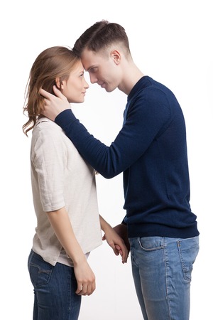 Young couple in love watching each other's eyes isolated on white backgroundの写真素材