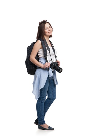 Young woman tourist with camera and backpack, isolated on whiteの写真素材