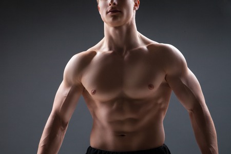 Close up of sexy male's chest, isolated on blackの写真素材