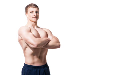 Muscular young man in studio on white background shows the different movements and body partsの写真素材