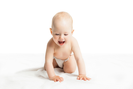 Adorable little boy baby sitting over white backgroundの写真素材