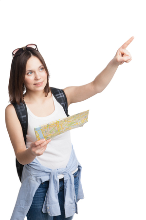 young pretty girl in looking for place on  map with rucksack over white backgroundの写真素材