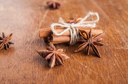 Close up of cinnamon sticks and star anise on rustic woodの写真素材
