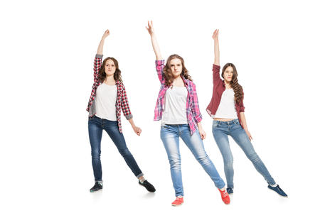 three young beautiful happiness women dancing over white backgroundの写真素材