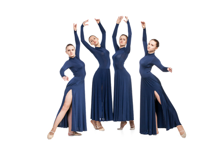 Group of young dancers in blue dresses dancing over white backgroudの写真素材