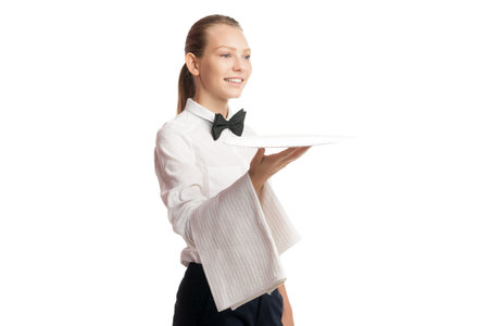 Portrait of smiling blonde waitress in uniform holding tray with towelの写真素材
