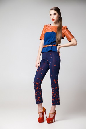 Portrait of girl with tail in stylish clothes and high heels.Studio shotの写真素材