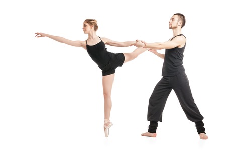 Young ballet couple in black dancing against of white background.Isolatedの写真素材