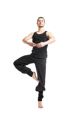 Black-haired man posing to camera in ballet stand.isolatedの写真素材