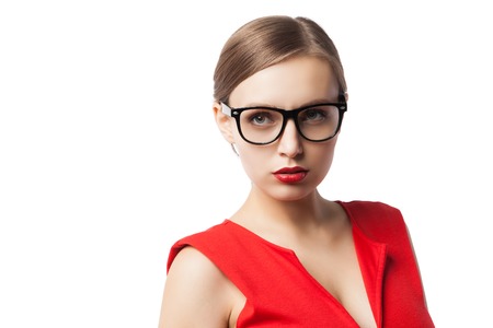 Portrait of successful confident woman in glasses and red dress with red lipstick on looking awayの写真素材