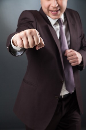 Close-up of unrecognizable businessman fighting at cameraの写真素材