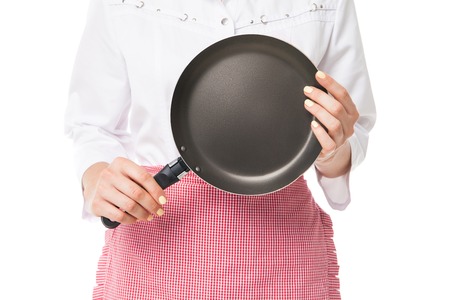 Close-up of unrecognizable woman with frying pan in handsの写真素材