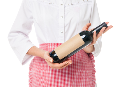 Unrecognizable woman in apron holding bottle of wine.Studio shotの写真素材