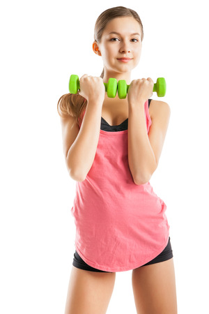 Smiling athletic woman pumping up muscles with dumbbells on white backgroundの写真素材