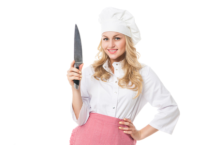 Portrait of beautiful smiling woman in uniform with knife.Isolated.Studio shotの写真素材