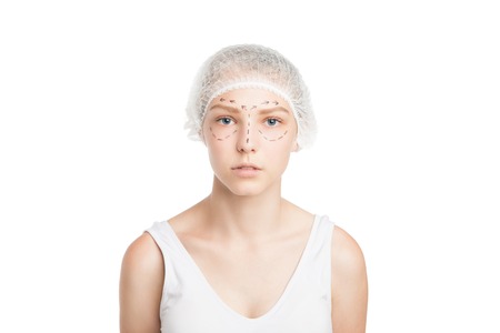 Portrait of young girl with outlined face for plastic surgery or lifting.Studio shotの写真素材