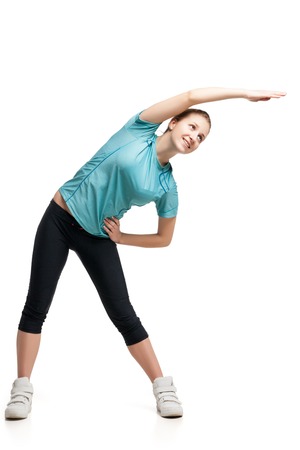 Beautiful sporty woman doing exercise . Isolated on white backgroundの写真素材