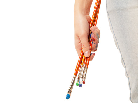 Hand holding brushes down. Isolated on whiteの写真素材