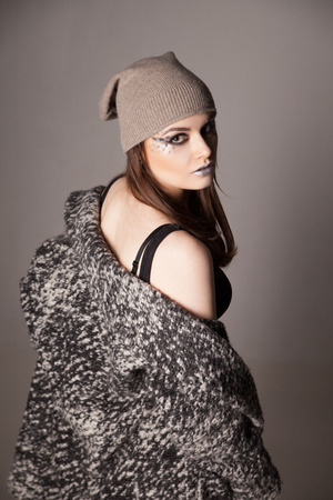 young woman turned and looking over her shoulder . Woman portrait standing back. Half viewの写真素材