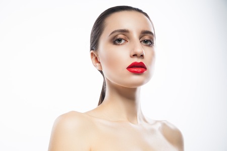 Attractive young female with red lips looking at camera. Horizontal studio shot.の写真素材