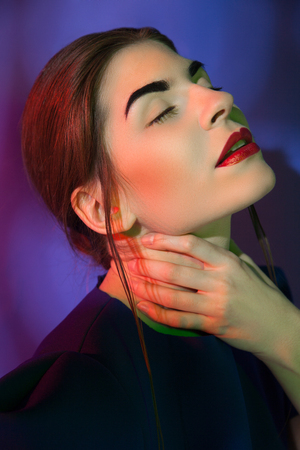 Attractive woman holding neckの写真素材