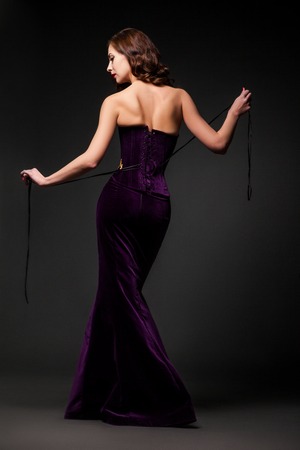 Woman posing in purple dressの写真素材