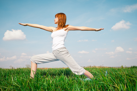 Young girl doing yoga in the parkの写真素材