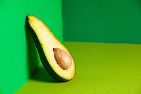 Half of healthy avocado in green box