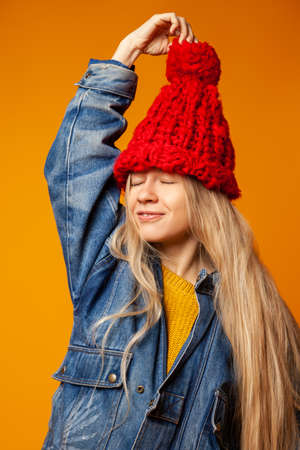 Trendy female teenager in red knitted hatの写真素材