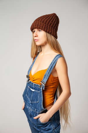 Positive hipster woman in trendy outfit against white backgroundの写真素材