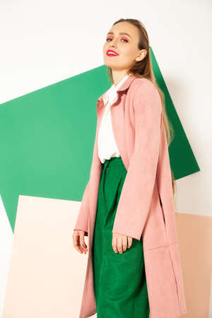 Elegant woman in stylish colorful wear in studio with white backgroundの写真素材