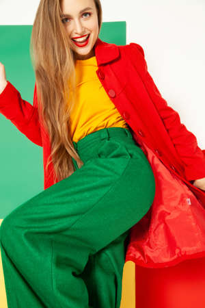 Smiling fashionable woman in bright colorful outfitの写真素材