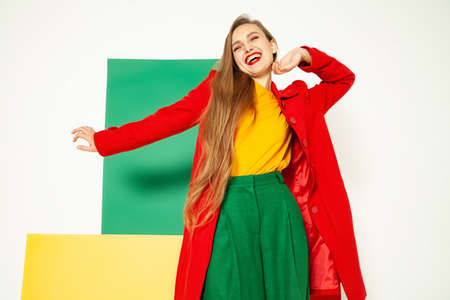Cheerful fashionable woman in bright multicolored outfitの写真素材
