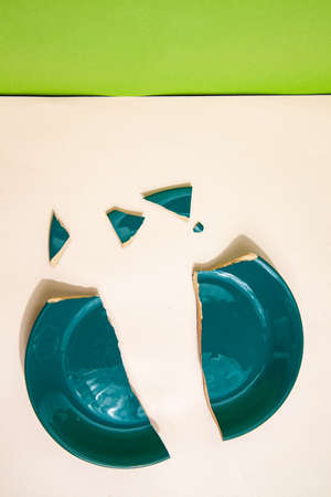 Pieces of broken plate on table in studioの写真素材