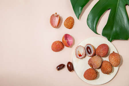 Fresh lychees on pink table in studioの写真素材