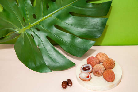 Fresh lychees on pink table in studioの写真素材