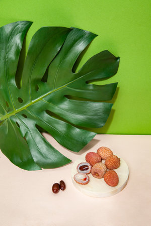 Fresh lychees on pink table in studioの写真素材