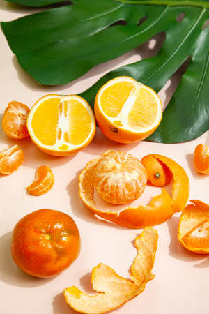 Ripe oranges and tangerines on table in studioの写真素材