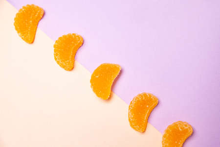 Fruit jelly candies arranged in diagonal row on colorful backgroundの写真素材