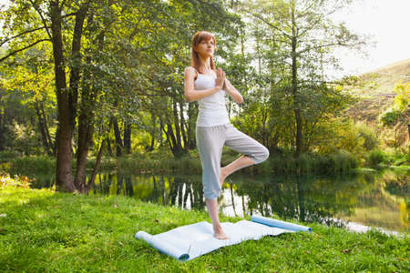 Young girl doing yoga in the parkの写真素材