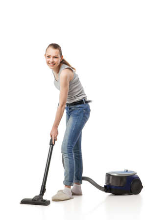 Young beautiful woman posing with vacuum cleaner over white backgroundの写真素材