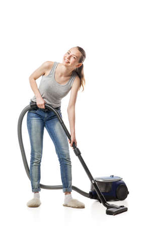Young beautiful woman posing with vacuum cleaner over white backgroundの写真素材