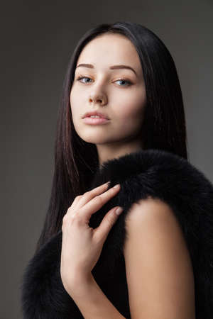 Beautiful Woman in Luxury Fur over gray backgroundの写真素材
